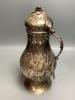 A Persian engraved white metal baluster flagon                                                                                                                                                                              