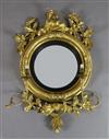 A Regency giltwood and gesso convex wall mirror, W.1ft 11in. H.2ft 7in.                                                                