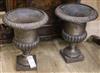 A pair of cast iron urns W.26cm                                                                                                        