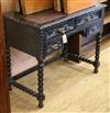 A late Victorian carved oak writing table W.90cm                                                                                       