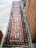 A Caucasian design brick red ground runner, 430 x 80cm                                                                                                                                                                      