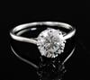 An 18ct gold and platinum set solitaire diamond ring, size N.                                                                          