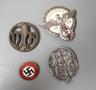 A WW2 German Hitler Youth Gausieger badge, a Wehrmachtgefolge badge for civilian workers, a Tag der Arbeit badge and an Adolf Hitler 1933 enamelled badge (4)                                                               