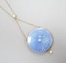 An Edwardian yellow metal, blue guilloche enamel and seed pearl set pendant necklace, pendant, 28mm, overall approx. 48cm, gross 11.3 grams.                                                                                
