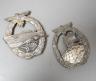 A WW2 German Kriegsmarine E-Boat Badge, marked FEC. W.E. PEEKHAUS BERLIN AUSF. SCWERN BERLIN 68 and an Auxiliary Cruiser War Badge (2)                                                                                      