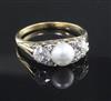 An early 20th century gold, split pearl and diamond set three stone ring, size P.                                                      