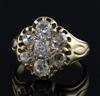 An early-mid 20th century gold and seven stone diamond cluster ring, size I.                                                           