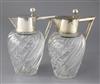 A stylish pair of early 20th century German 800 standard silver mounted wrythened glass claret jugs, 22.5cm.                           