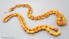 Two single strand graduated oval amber bead necklaces, 71cm, 61 grams & 89cm, 68 grams (beads missing from larger necklace)                                                                                                 