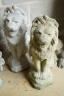 A pair of reconstituted stone seated lion garden ornaments, height 56cm                                                                                                                                                     
