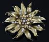 A gold and diamond 'chrysanthemum' brooch by Garrard, set with 22 brilliants (tests as 18ct), cased, gross 47 grams.                   