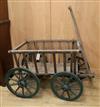 A Victorian wooden four wheel cart with slatted sides W.70cm                                                                           