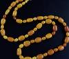 A single strand oval amber bead necklace, 104cm.                                                                                       