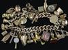 A 9ct gold charm bracelet, hung with thirty three assorted gold charms, gross 69.3 grams.                                              