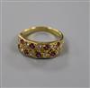 A modern 18ct gold and twin row ruby and diamond half hoop ring, size M.                                                               