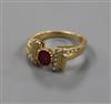 A modern 18ct gold and ruby set ring, with diamond set setting and shoulders, size M.                                                  