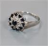 A modern 18ct white gold, sapphire and diamond cluster dress ring, size S.                                                             