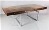 A Bodil Kjær rosewood freestanding 'working table' desk with underframe of chromed steel W.6ft 7in. D.3ft 3in. H.2ft 3in.              