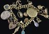 A 9ct gold charm bracelet, hung with twenty one assorted charms, gross 51 grams.                                                       