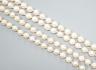 A modern long single strand cultured pearl necklace, with fluted 14k and diamond chip set clasp, 116cm.                                                                                                                     