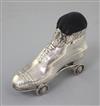 An Edwardian novelty silver roller skate pin cushion on rotating wheels, by Crisford and Norris, Birmingham 7cm.                       