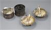 A pair of silver shell salts with two spoons and two napkin rings, one silver.                                                         