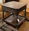 A carved oak two tier table W.61cm                                                                                                     