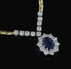 An 18ct two colour gold, sapphire and diamond oval cluster pendant necklace, 42cm                                                      