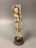 A Chinese ivory figure of Hua Mulan, early 20th century, height 26cm including wood stand                                                                                                                                   