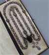 An early 20th French amethyst bead necklace, with white metal cross pendant drop, approx. 90cm.                                        