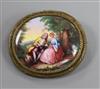 A gilt metal mounted mother of pearl oval panel, painted with lady and gentleman in woodland scene, 50mm.                              