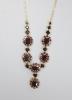 A 20th century 585 yellow metal and garnet cluster set necklace                                                                                                                                                             