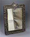 An Edwardian repousse silver mounted easel mirror by Walker & Hall, Sheffield, 1902, overall 40.2cm.                                   