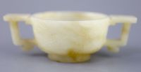 A Chinese pale celadon and russet jade cup, 17th/18th century, 12.5cm wide                                                             