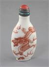 A Chinese iron red enamelled 'dragon' snuff bottle, 19th century, height 7.6cm excl. coral and enamelled silver stopper                