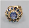 A yellow metal and sapphire set hexagonal openwork cluster ring, size J.                                                               