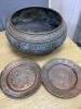 A large Eastern brass bowl cast with bands of seated deities, foliate scrolls and linear decoration and a pair of copper dishes                                                                                             