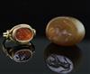 An antique gold and intaglio ring and an intaglio pendant, size H.                                                                     