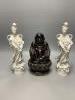 A Chinese dark brown glazed Buddha, and a pair of blanc de chine figures of Guanyin, tallest 30cm                                                                                                                           