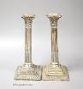 A pair of Edwardian silver corinthian column candlesticks, Walter Latham & Son, Sheffield, 1904, 24.5cm, weighted (a.f.).                                                                                                   