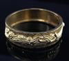 A Chinese high carat gold hinged bangle,                                                                                               