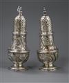 A pair of George II silver pepperettes, with later embossed decoration, Samuel Wood, London, 1748, 14cm.                               