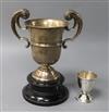 A George V silver trophy cup by Walker & Hall and a silver egg cup.                                                                    