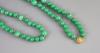 A Chinese green jadeite bead necklace, 51cm drop                                                                                                                                                                            