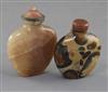 A Chinese pudding stone snuff bottle and a Chinese crystal snuff bottle, 19th century, 6.4cm and 7.7cm incl. stoppers                  