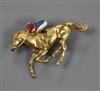 A 9ct gold and enamel horse and jockey brooch (a.f.), 37mm.                                                                            