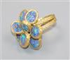 A 1970's? textured 18ct gold and eight stone oval black opal set dress ring, size K/L.                                                 