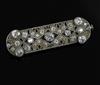 A Belle Epoque platinum? and millegrain set diamond pierced ovoid brooch, 43mm.                                                        