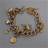 A 9ct gold charm bracelet hung with seven assorted charms including 9ct gold coffee pot.                                               