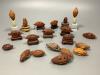 An assortment of Chinese peach stone and nut carvings                                                                                                                                                                       